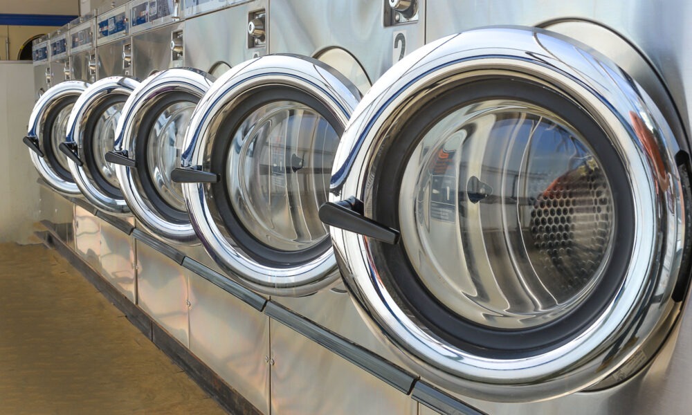 Close up of washing machine fronts in a laundrette.