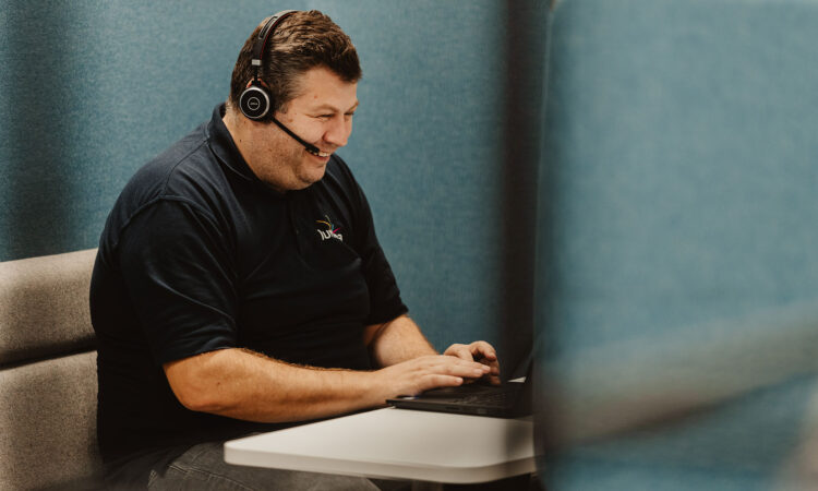 Our team member Kevin Still on the telephone at the office