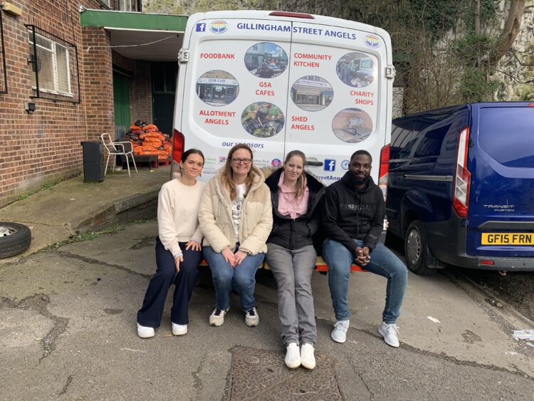 Members of the Lumina Energy team sitting on the van of Gillingham Street Angels Charity.